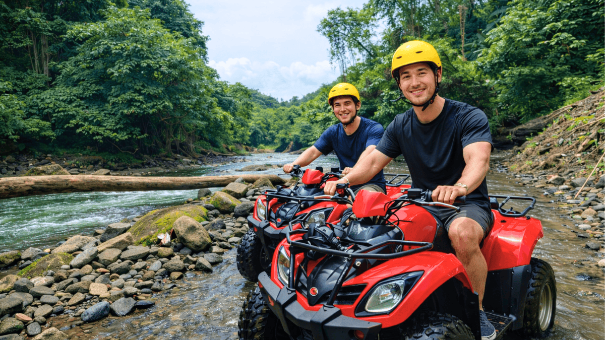 Two travelers riding ATVs through a river in a tropical forest in Bali.