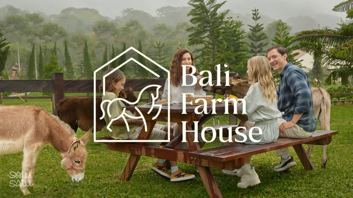 Family having lunch accompanied by animals at Bali Farm House