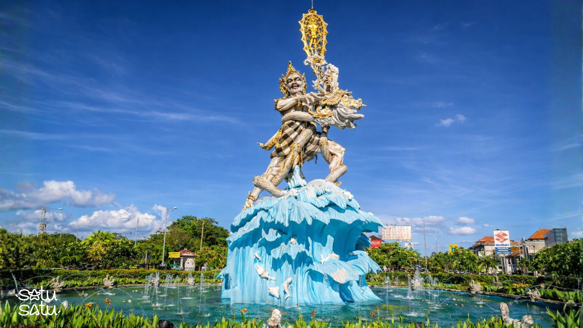 Dewa Ruci statue in Kuta, Bali, featuring a mythological figure standing on ocean waves at a roundabout fountain.