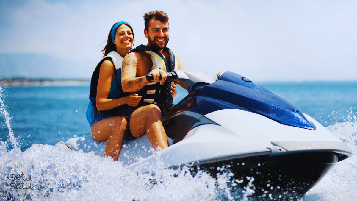 Couple riding a jet ski in Tanjung Benoa Bali enjoying an exciting water sports adventure