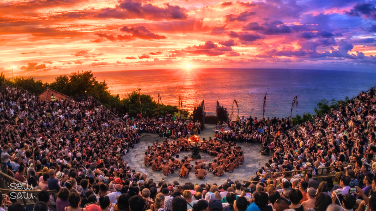 Kecak fire dance performance at sunset in Uluwatu Temple Bali with dramatic ocean backdrop