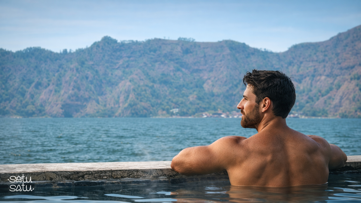 Traveler relaxing in Kintamani hot springs with scenic lake and mountain views in Bali.