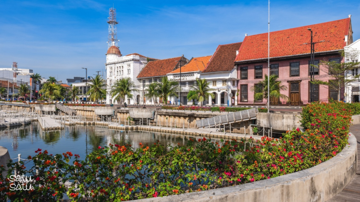 Historic colonial buildings and waterfront promenade in Kota Tua, Jakarta Old Town.