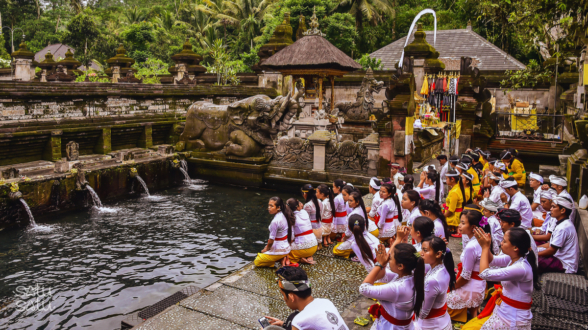 Worshippers participating in a purification ritual at Tirta Empul Temple holy spring in Bali, Indonesia