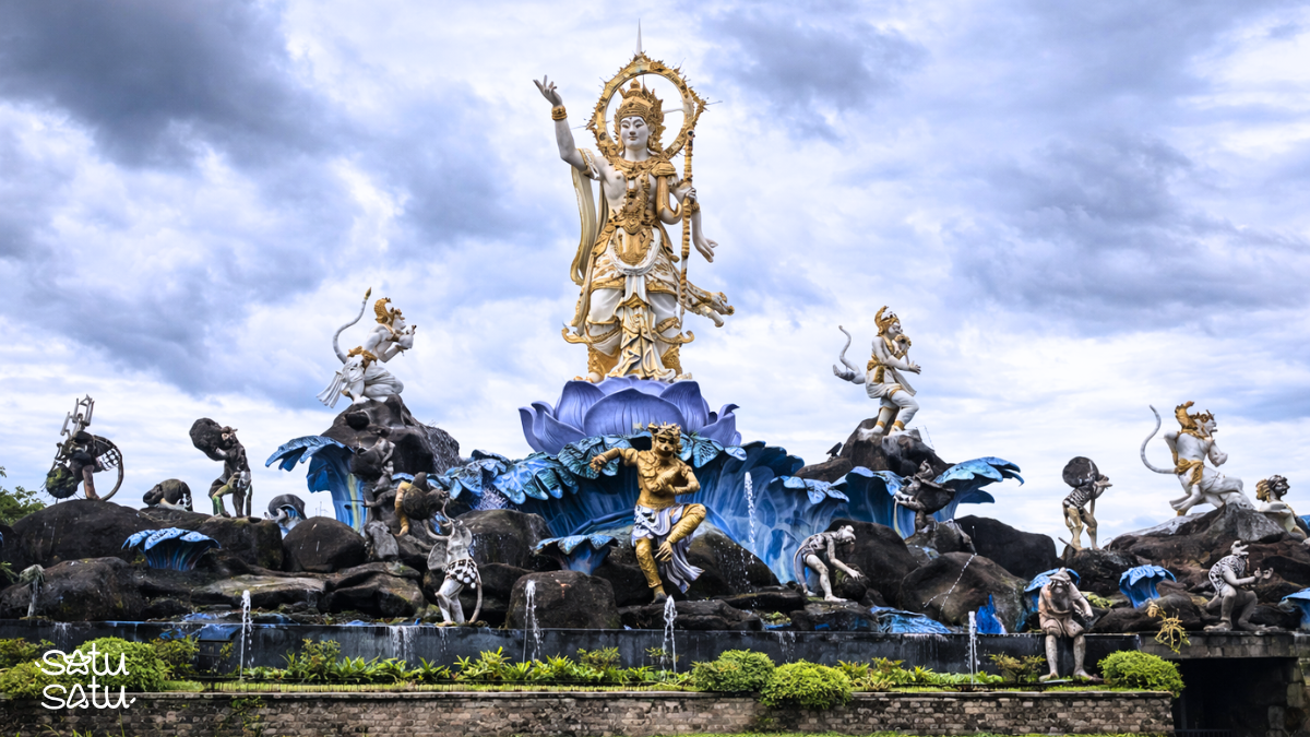 Titi Banda statue in Denpasar, Bali, featuring a large mythological figure surrounded by dynamic sculptural elements and fountains.